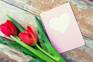 Image showing close up of tulips and greeting card with heart