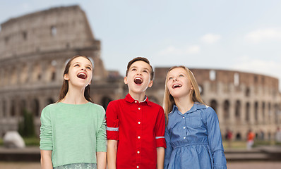 Image showing amazed children looking up over coliseum in rome