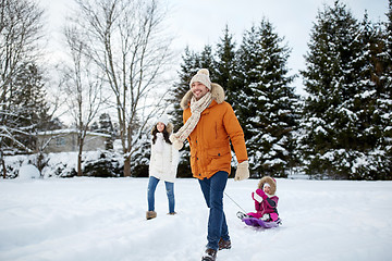 Image showing happy family with sled walking in winter outdoors