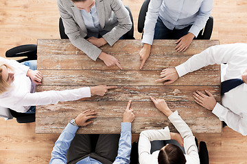 Image showing close up of business team sitting at table