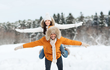 Image showing happy couple having fun over winter background