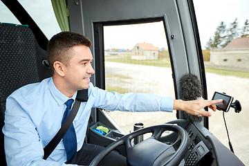 Image showing bus driver entering address to gps navigator