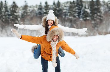 Image showing happy couple having fun over winter background