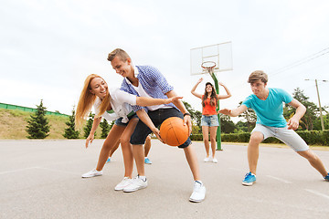 Image showing group of happy teenagers playing basketball