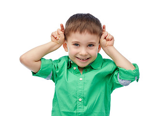 Image showing happy little boy having fun and making horns