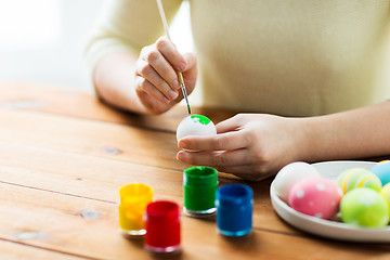 Image showing close up of woman hands coloring easter eggs