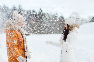 Image showing happy couple playing with snow in winter