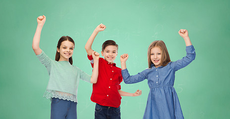 Image showing happy boy and girls celebrating victory