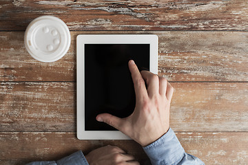 Image showing close up of male hands with tablet pc and coffee