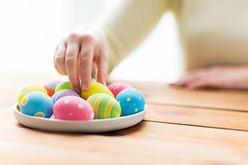 Image showing close up of woman hands with colored easter eggs