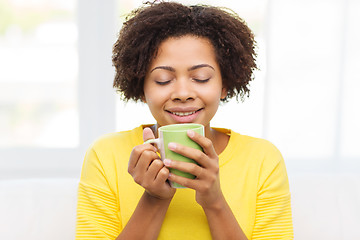 Image showing happy african american woman drinking from tea cup