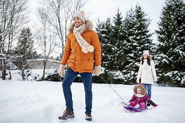 Image showing happy family with sled walking in winter outdoors