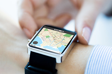 Image showing close up of hands with map on smartwatch screen