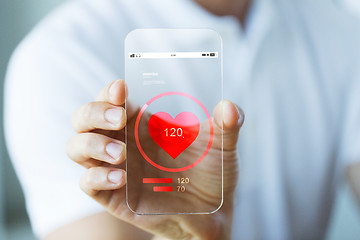 Image showing close up of hand with heart rate on smartphone