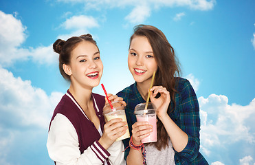 Image showing happy pretty teenage girls drinking milk shakes
