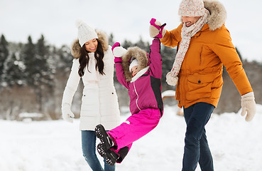 Image showing happy family in winter clothes walking outdoors