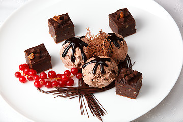 Image showing Chocolate ice cream with bonbons and red currants