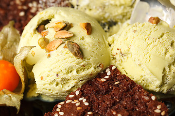 Image showing Pistachio ice cream topped with nuts