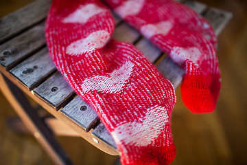 Image showing Red socks with heart pattern on wooden chair