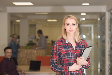 Image showing portrait of young business woman at office with team in backgrou