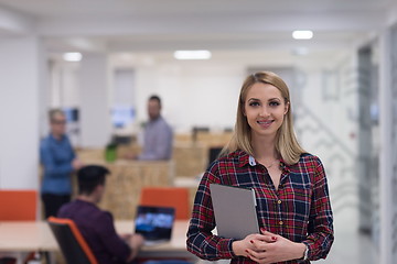 Image showing portrait of young business woman at office with team in backgrou