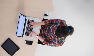 Image showing top view of young business woman working on laptop