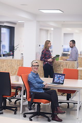 Image showing portrait of young business woman at office with team in backgrou