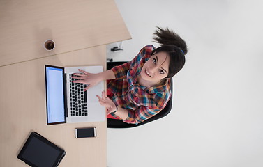 Image showing top view of young business woman working on laptop