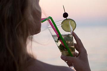 Image showing Woman drinking mojito cocktail