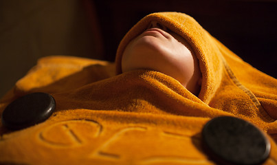 Image showing Woman getting hot towel treatment at beauty spa