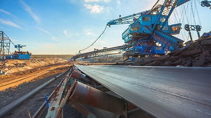 Image showing Long conveyor belt transporting ore