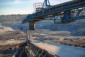 Image showing Long conveyor belt transporting ore