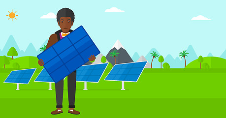 Image showing Man holding solar panel.