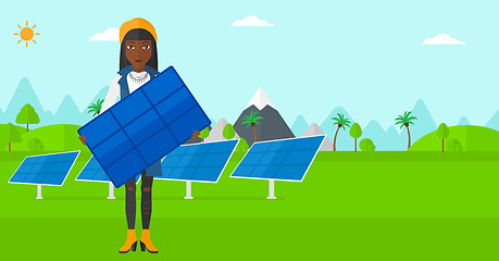 Image showing Woman holding solar panel.