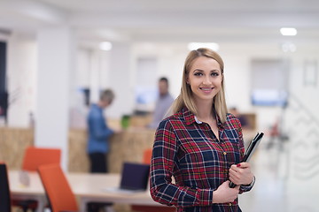 Image showing portrait of young business woman at office with team in backgrou