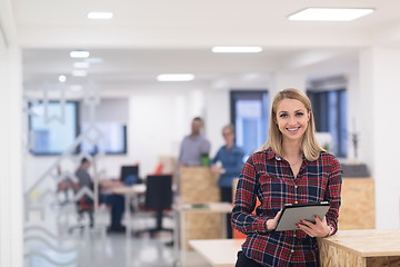 Image showing portrait of young business woman at office with team in backgrou