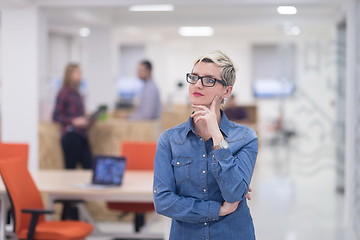 Image showing portrait of young business woman at office with team in backgrou