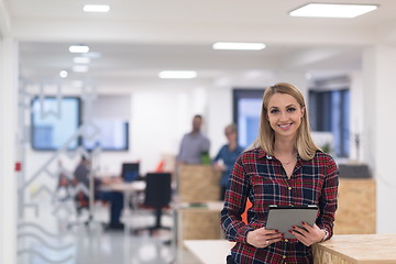 Image showing portrait of young business woman at office with team in backgrou