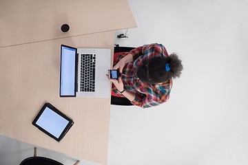 Image showing top view of young business woman working on laptop