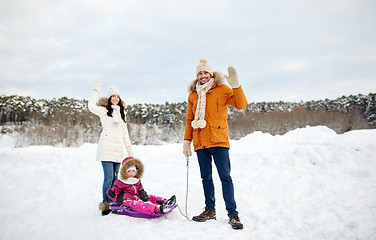 Image showing happy family with sled walking in winter outdoors