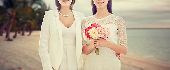 Image showing close up of happy lesbian couple with flowers