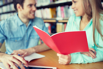 Image showing close up of students with notebooks in library