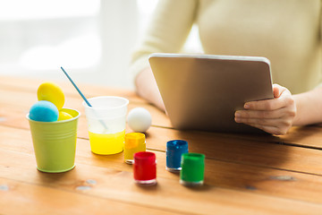 Image showing close up of woman with tablet pc and easter eggs