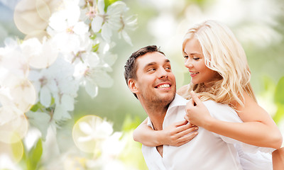 Image showing happy couple over cherry blossoms background