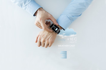 Image showing hands with weather forecast app on smart watch