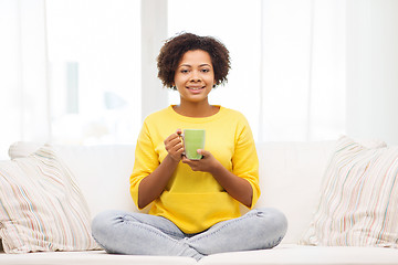 Image showing happy african american woman drinking from tea cup