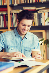 Image showing happy student reading book and drinking coffee