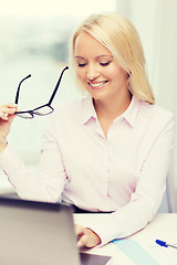 Image showing smiling businesswoman or student with laptop