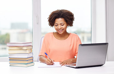 Image showing happy african american woman with laptop at home