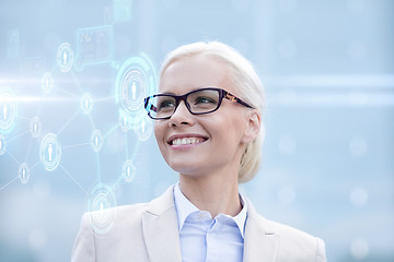 Image showing young smiling businesswoman in eyeglasses outdoors